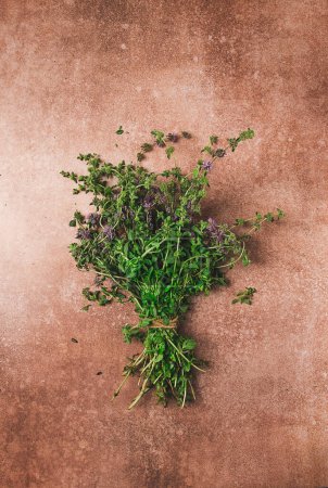 Photo for Bouquet of herb ombalo, marsh mint, bunch of mint, top view, on a brown background, spice, Georgian cuisine, - Royalty Free Image