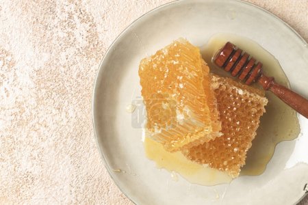 Photo for Honeycomb, with a wooden spoon-spindle, on a plate, no people, - Royalty Free Image