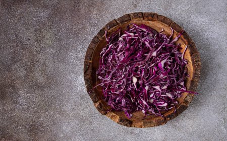 red cabbage, sliced, in a wooden salad bowl, top view, no people,