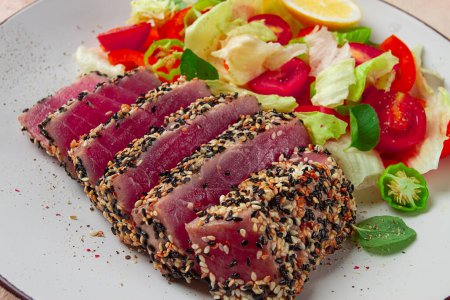 fillet of red tuna meat, fried in sesame seeds, homemade, close-up, no people, on a wooden background,