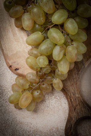 Photo for A branch of white grapes, wine grapes, Georgian grape variety Rkatsiteli, top view, - Royalty Free Image