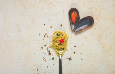 spaghetti strung on a fork, mussel, on the table, dish concept, dish background, top view,