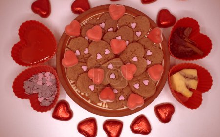 Vegetarian cookies of different types of hearts made using plungers. Decorated with natural juices thickened with agar-agar. Gold background.