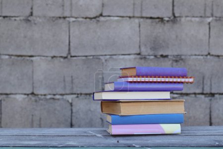 Téléchargez les photos : Pile de livres sur fond de table en bois - en image libre de droit