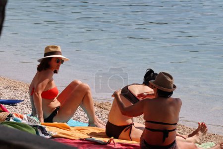 Photo for Makarska, Croatia, 02.06.2023.Tourists enjoy their annual vacation in Croatia, on the beach by the sea - Royalty Free Image