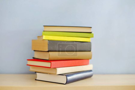 stack of books on table against light background. space for text