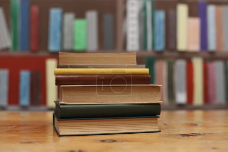 stack of books on the table in classroom, book, pile of old books on wooden shelves,stack of books on wooden table in library, stack of books in the store, blurred background, school, education, library, bookshop