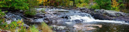 Photo for Waterfalls flowing into Lake of the Falls in Mercer, Wisconsin in September, panorama - Royalty Free Image