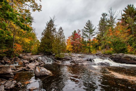 Photo for Waterfalls flowing into Lake of the Falls in Mercer, Wisconsin in September, horizontal - Royalty Free Image