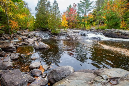 Photo for Waterfalls flowing into Lake of the Falls in Mercer, Wisconsin in September, horizontal - Royalty Free Image