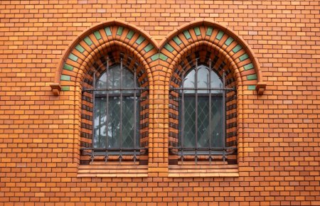 Arch windows in the facade, made of brick tiles, of the Church of Visitation of Virgin Many . Neo-gothic building on the place of historical church. Postorna, Breclav, Moravia, Czech republic.