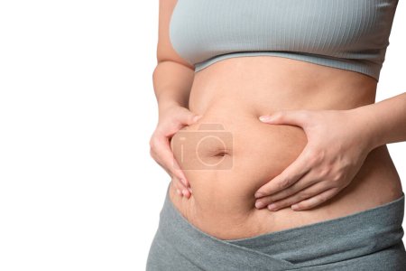 Téléchargez les photos : Femme joufflu main tenant la graisse du ventre, concept de mode de vie alimentation femme, isoler sur fond blanc. - en image libre de droit