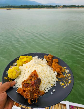 Photo for Bangladesh's traditional food served on a boat during the lunch time showing rice, fish, chicken and other Bangladeshi foods. - Royalty Free Image