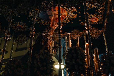 Photo for April 8th 2023 - Dona Mencia, Cordoba, Spain. Procession of the Virgen de la Soledad . Spanish Celebration of Holy Week. Vertical shot, Virgen de la Soledad, Good Friday, low-angle shot, warm light - Royalty Free Image