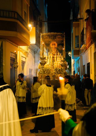Photo for April 8th 2023 - Dona Mencia, Cordoba, Spain. Procession of the Virgen de la Soledad . Spanish Celebration of Holy Week. Vertical shot, Virgen de la Soledad, Good Friday, low-angle shot, warm light - Royalty Free Image