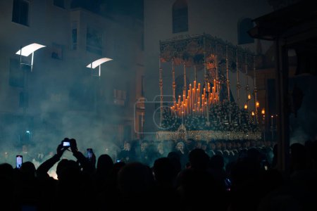 Photo for April 8th 2023 - Dona Mencia, Cordoba, Spain. Crowd of people using Mobile phone, taking pictures and recording Virgin of Solitude in the spanish celebration of Holy Week. Easter in Spain, devotee - Royalty Free Image