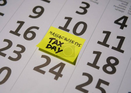 Calendar closeup pointing at April 17th 2024, Tax Day in Massachusetts, the USA for 2023 earnings. High quality photo