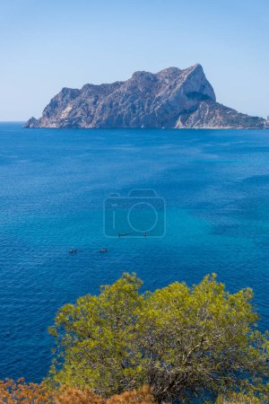 Beautiful vertical landscape of Penyal d Ifach, with canoes or kayaks sailing along the coast. Active tourism, adventure, activity, recreation, Calpe Benissa, province of Alicante, Spain, Benidorm