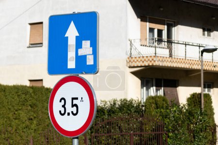 Damaged traffic signs with stickers, maximum gross weight and one way direction traffic signs