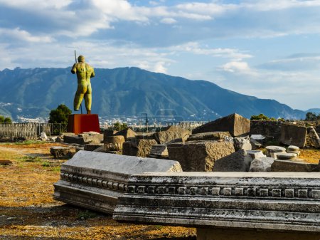 Amazing ruins of Pompeii ancient city with a statue of polish sculptor Igor Mitoraj in background, Naples, Italy