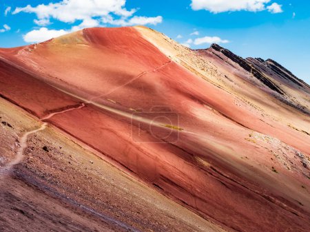 Amazing colors of the Red Valley (valle rojo) with stunning path leading to the top of the mountain, Cusco region, Peru