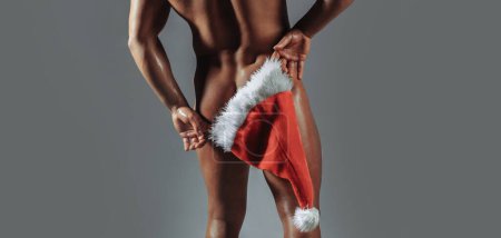 Christmas sexy man. New year strip and gifts for adults. Muscle man torso with sexy buttocks butt. Santa with muscular body back