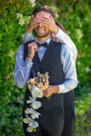Photo for Gay couple wedding, marriage. Loving gay male couple. Men close eyes with hands, play guess who or hide and seek - Royalty Free Image