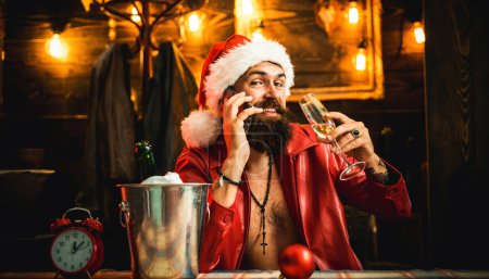 Photo for New Year Christmas drinking. Drank Santa. Santa Claus wishes Merry Christmas and happy new year. Handsome Santa drink champagne. Santa waiting for New Year midnight - Royalty Free Image