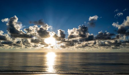 Photo for Sunset on tropical dramatic beach sea ocean with sunrise clouds. Banner for travel vacation. Scenery sky and reflection rays in water. Tropical beach seascape horizon. Dusk, twilight on sea - Royalty Free Image
