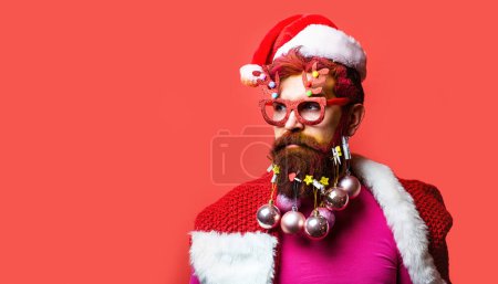 Photo for Portrait of a Santa Claus on red background isolated. Christmas people. Bearded modern Santa Claus in Christmas mood. - Royalty Free Image