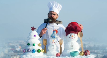 Photo for Winter cooking. Snow man cook chef on the snow outdoor background. Christmas banner with snowman. Winter greeting card with with snowman. Winter background - Royalty Free Image