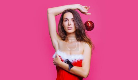 Photo for Portrait of a beautiful woman celebrate winter holidays hold christmas balls isolated on red background Young beautiful girl with christmas ball. Close up photo of sexy lady. Happy new year - Royalty Free Image