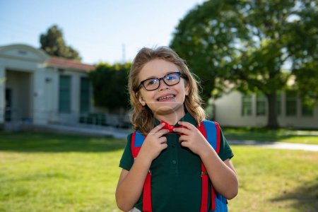 Photo for School, kids education concept. Child with rucksacks standing in the school park. Pupil with backpacks outdoors - Royalty Free Image