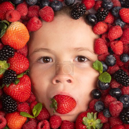 Photo for Strawberry, blueberry, raspberry, blackberry background on child face. Healthy kids eating. The kids face with fruit and berries - Royalty Free Image