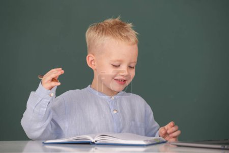 Photo for School child student learning in class, study english language at school. Kid writing in notebook in class. Education and kids knowledge concept - Royalty Free Image