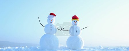 Photo for Funny couple of two snowman holding hands outdoors. Snowman on the snow outdoor background. Christmas banner with snowman. New year greeting card with with snowman - Royalty Free Image