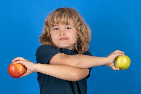 Photo for Healthy eating. Little funny boy holding apple with fynny face. Kid eats healthy food - Royalty Free Image