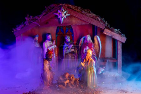 Photo for Christmas birth of Jesus. Christmas manger scene with figurines including Jesus, Mary, Joseph, lamb. Biblical Mary holding baby Jesus. Christmas theme - Royalty Free Image