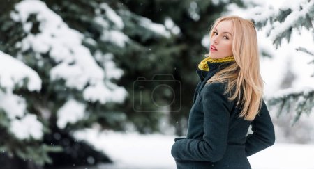 Photo for Winter woman in winter snowy background outdoor. Portrait of young beautiful woman wearing coat. Model walking in winter street - Royalty Free Image