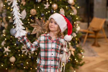 Photo for Child at home on Christmas. Little kid celebrating Christmas or New Year - Royalty Free Image