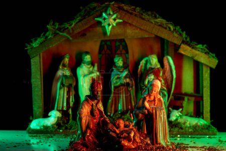Photo for Nativity scene with figures. A Christmas scene with baby Jesus, Mary and Joseph in the manger. Bethlehem. Christian religious. The Blessed Virgin Mary, Saint Joseph and baby Jesus - Royalty Free Image