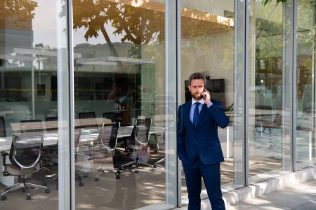Photo for Portrait of a confident mature businessman standing outside office - Royalty Free Image