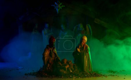 Photo for Christmas creche with Joseph Mary and Jesus. Christmas Manger scene with figurines including Jesus, Mary, Joseph, sheep and magi. Selective focus - Royalty Free Image