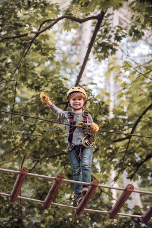 Toddler age. Balance beam and rope bridges. Carefree childhood. Kids boy adventure and travel. Artworks depict games at eco resort which includes flying fox or spider net