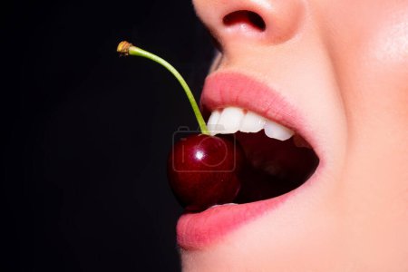 Photo for Cherry in teeth, macro, close up. Cherry in woman mouth. Cherries on woman lips. Girl biting cherry. Beautiful girl, cherries in mouth - Royalty Free Image