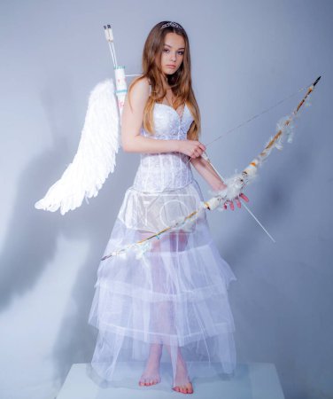 Photo for Angel girl with blonde hair. Teenager Cupid. Valentines day. Girl dressed as an angel on a light background. Concept of innocent girl - Royalty Free Image