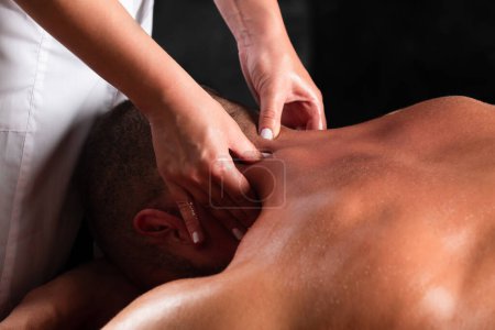 Photo for Massage for man close up. Physiotherapist massaging male neck. Man relaxing on massage table receiving massage - Royalty Free Image