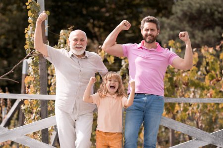 Foto de Familia multigeneracional. Emocionado abuelo padre e hijo al aire libre. Tres generaciones de hombres. Familia de hombres felices - Imagen libre de derechos
