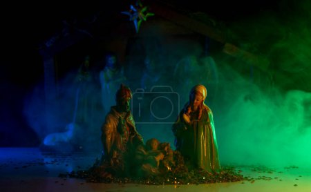 Photo for Christmas manger scene with figurines including Jesus, Mary, Joseph, lamb. Biblical Mary holding baby Jesus. Christmas theme. Selective focus - Royalty Free Image