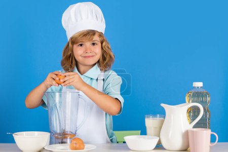 Photo for Cooking children. Chef kid boy making fresh vegetables for healthy eat. Portrait of little child in form of cook isolated on grey background. Kid chef. Cooking process - Royalty Free Image